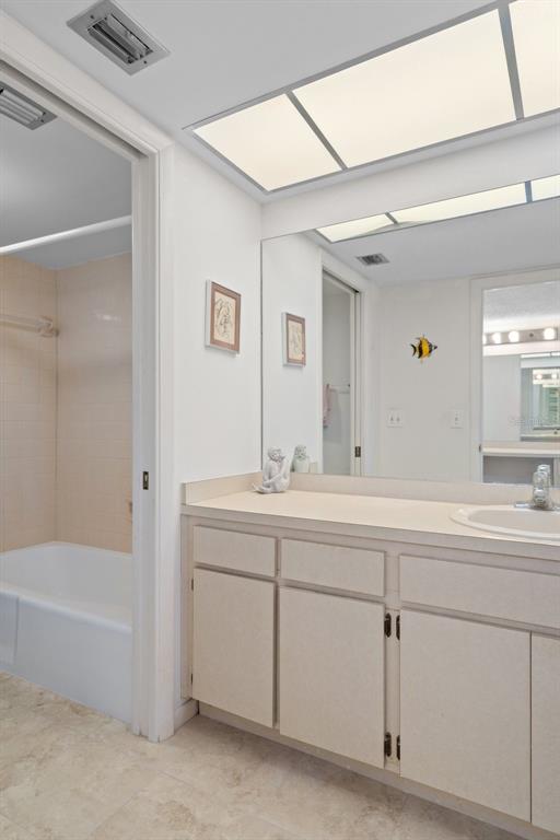 8211 Brent Street, Unit 816 Port Richey, FL 34668 - Photo 27 of 52 a bathroom with a tub sink and mirror