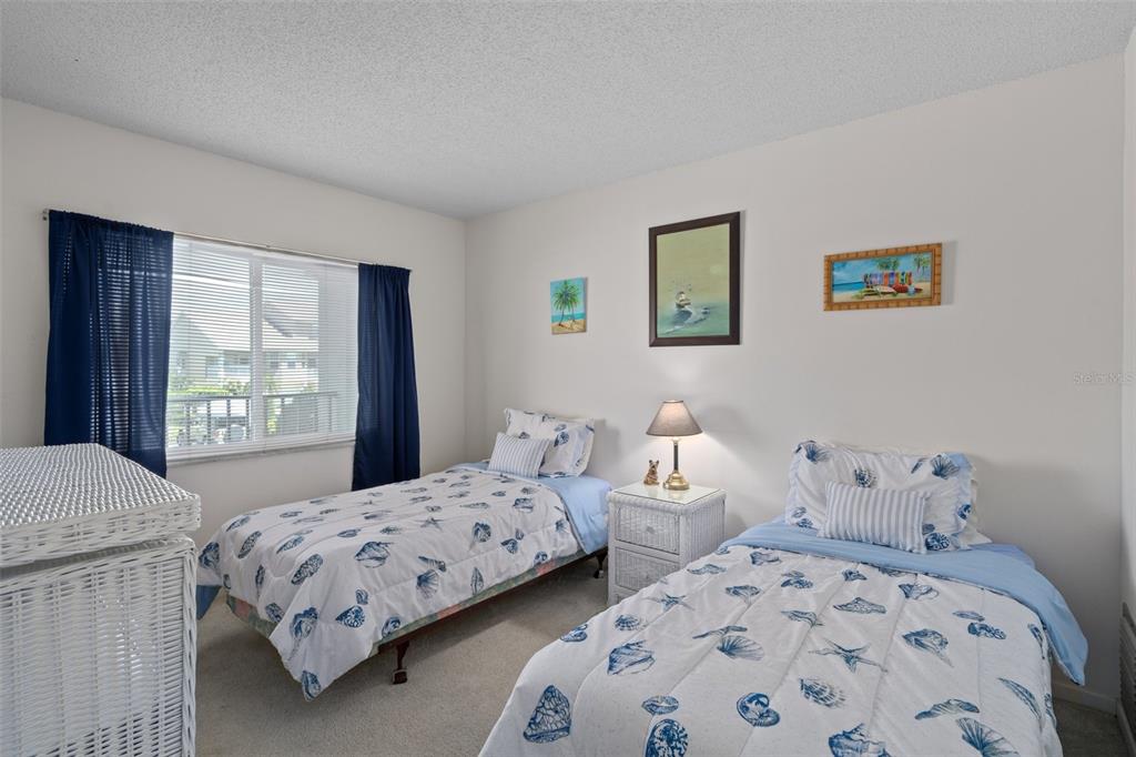 8211 Brent Street, Unit 816 Port Richey, FL 34668 - Photo 30 of 52 a bedroom with two beds and window