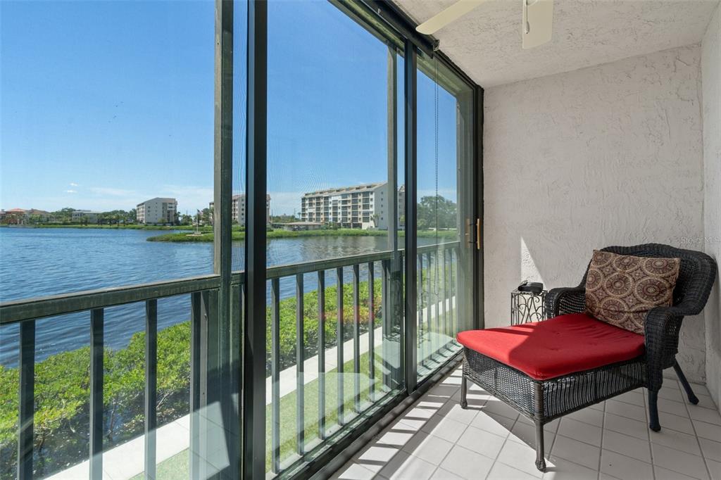 8211 Brent Street, Unit 816 Port Richey, FL 34668 - Photo 33 of 52 a view of a balcony with chair and wooden floor