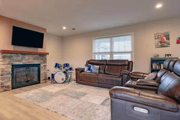 a living room with furniture a flat screen tv and a fireplace