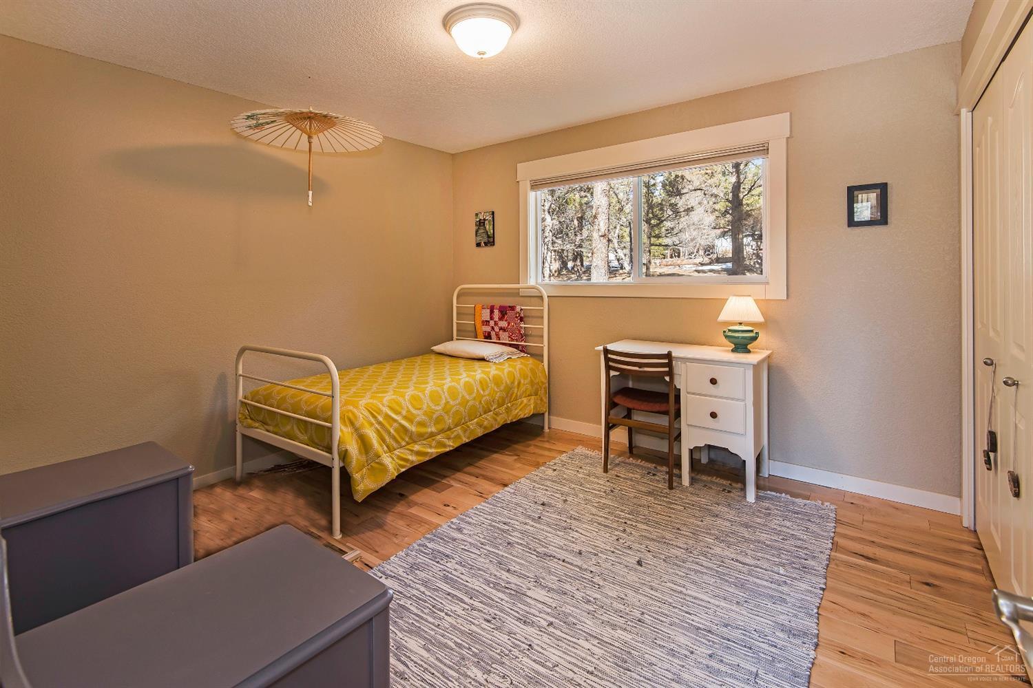 16033 Cattle Drive Road Sisters, OR 97759 - Photo 16 of 22 a bedroom with a bed and a window