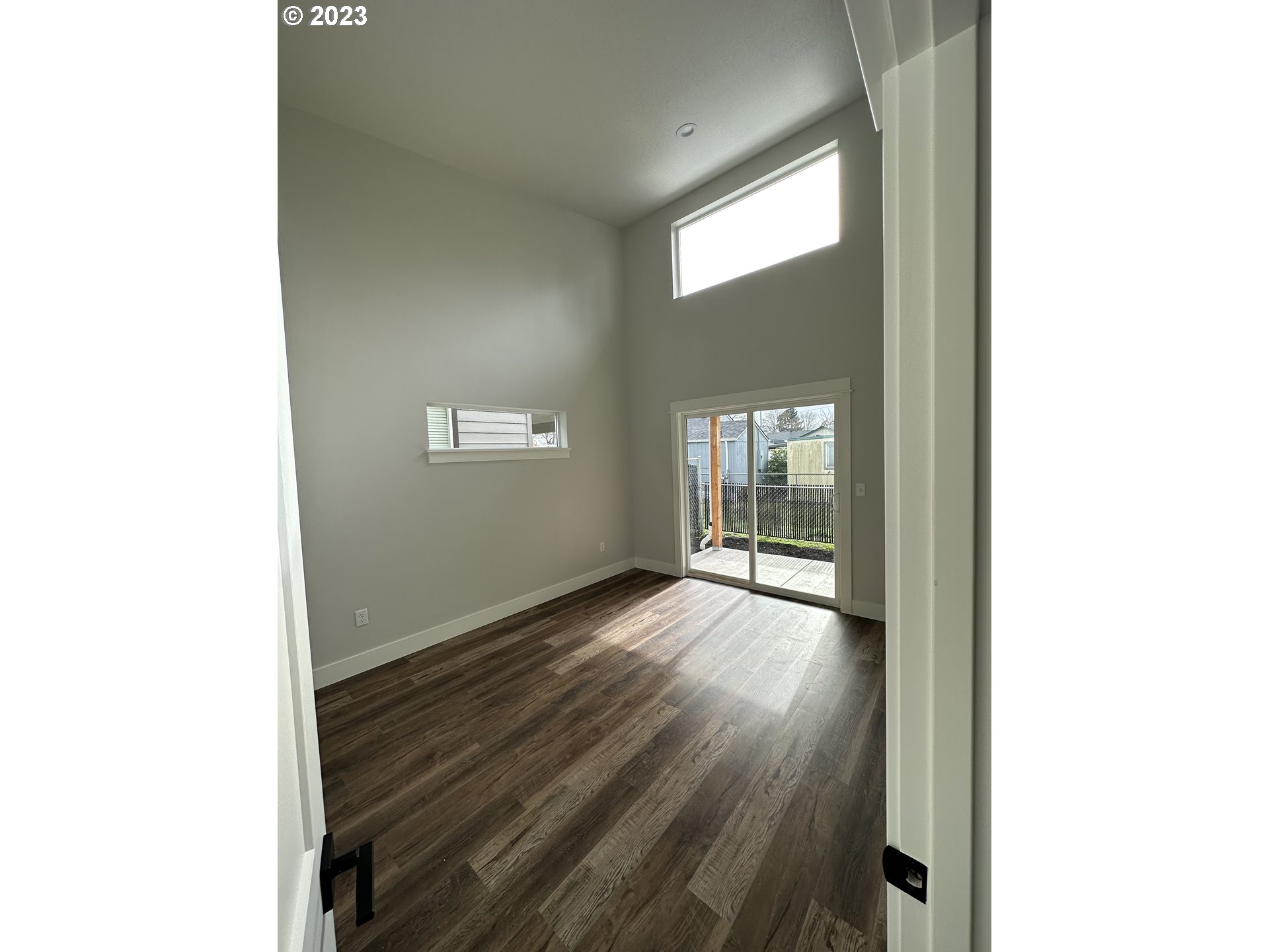 348 19th Springfield, OR 97477 - Photo 7 of 11 a view of an empty room with wooden floor and a window