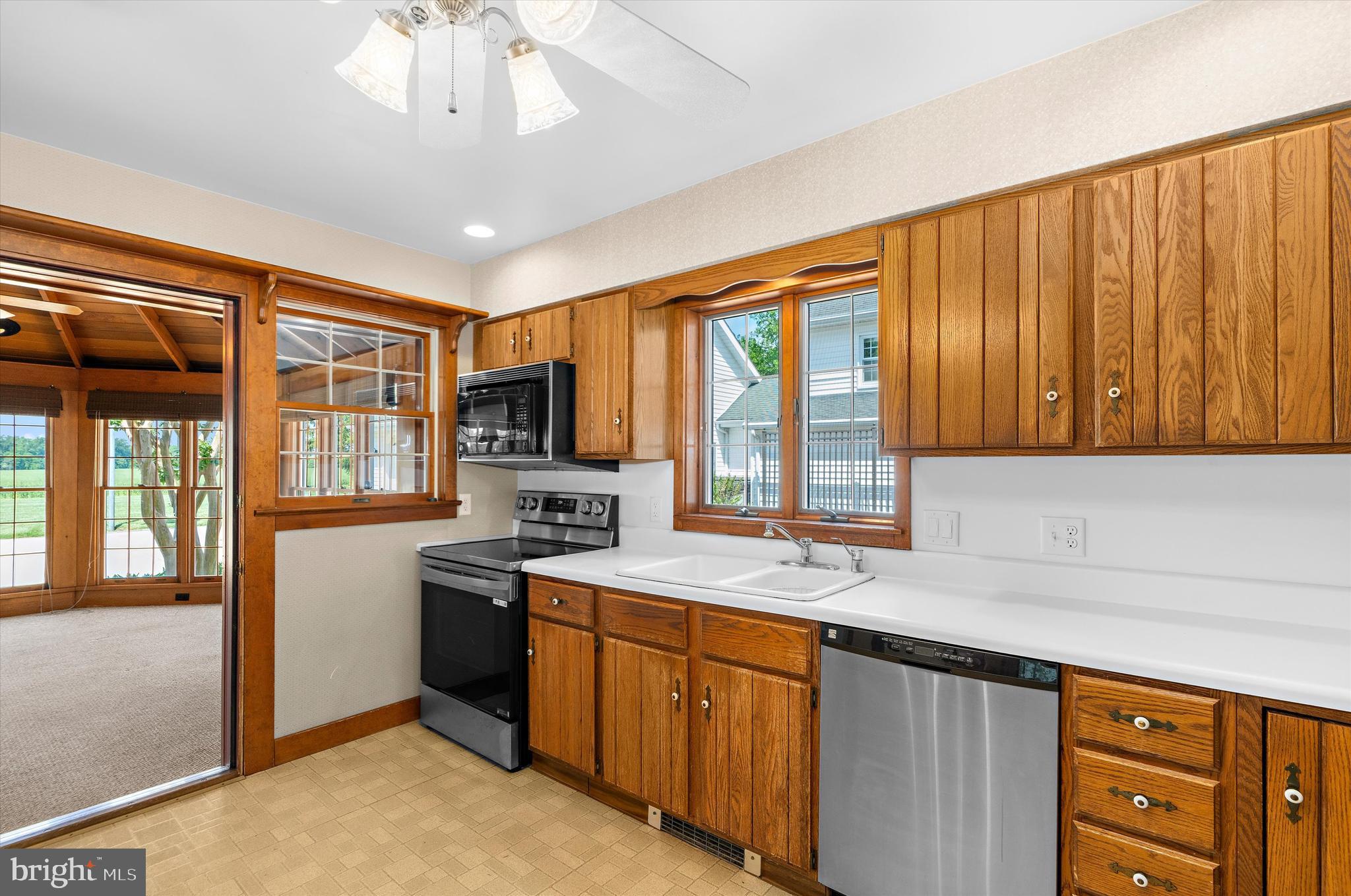 12714 Still Pond Road Still Pond, MD 21667 - Photo 7 of 62 a kitchen with stainless steel appliances granite countertop a refrigerator a sink dishwasher a stove and a dining table with wooden floor