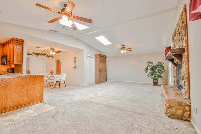 a view of a livingroom with furniture and a ceiling fan