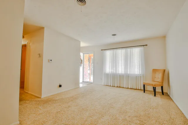 a view of room with furniture and windows