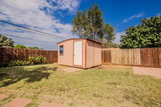 a view of an outdoor space with wooden fence