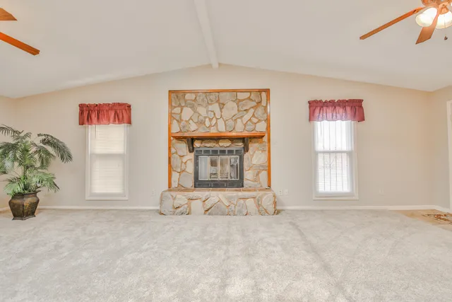 an empty room with windows and cabinet