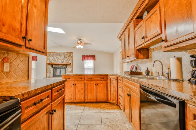 a kitchen with stainless steel appliances granite countertop a sink and cabinets