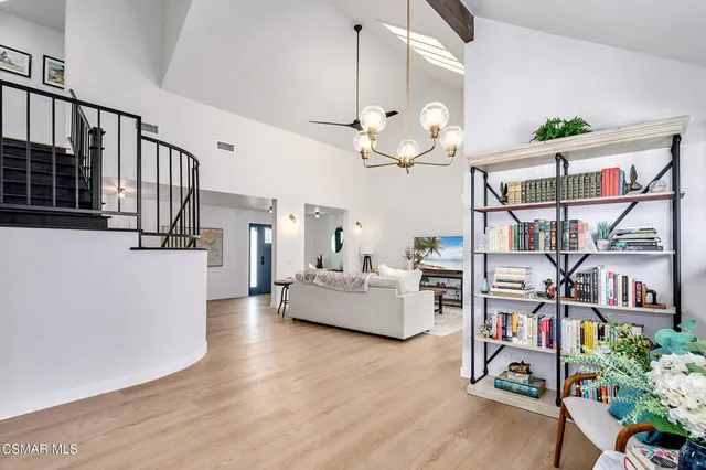 a view of entryway livingroom and hall with wooden floor