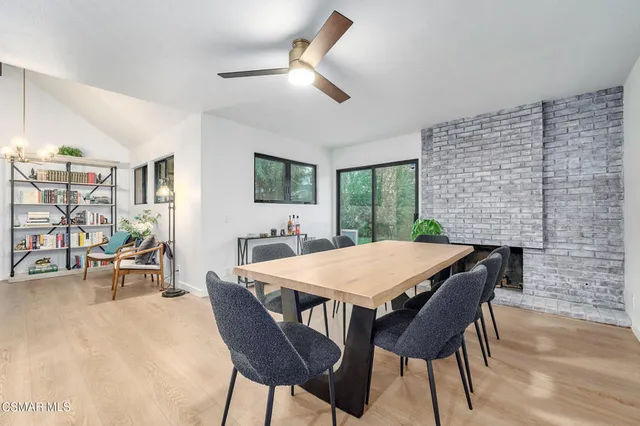 a dining room with a wooden table and chairs