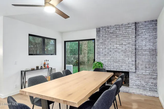 a view of a dining room with furniture and a chandelier