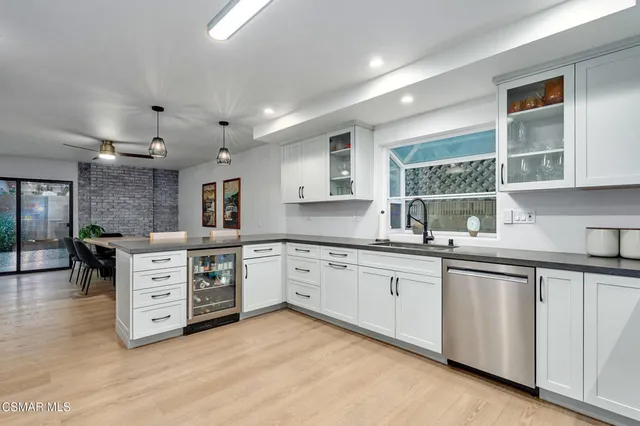 a kitchen with stainless steel appliances a refrigerator sink and cabinets