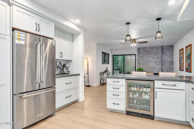 a kitchen with stainless steel appliances a refrigerator stove and cabinets