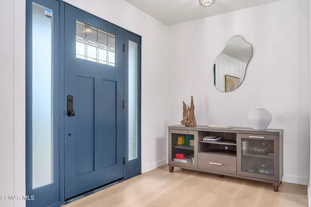 a room with a mirror and a lamp