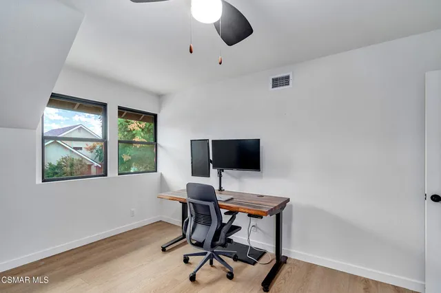 a front view of a house with a yard table and chairs