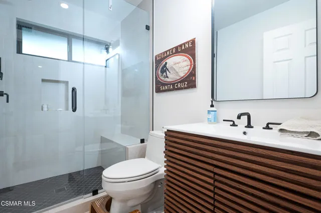 a front view of a house with a garden and plants