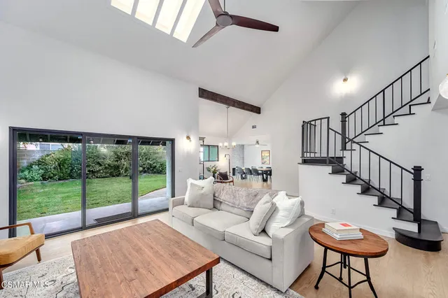 a living room with furniture and a floor to ceiling window