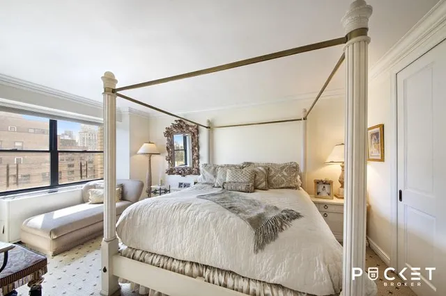 a bedroom with a large bed and a large window