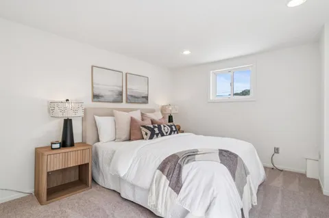 a spacious bedroom with a bed and cabinet