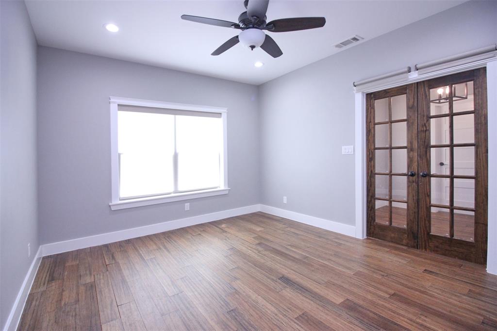 3238 Fm 2048 Boyd, TX 76023 - Photo 13 of 38 an empty room with wooden floor chandelier fan and windows