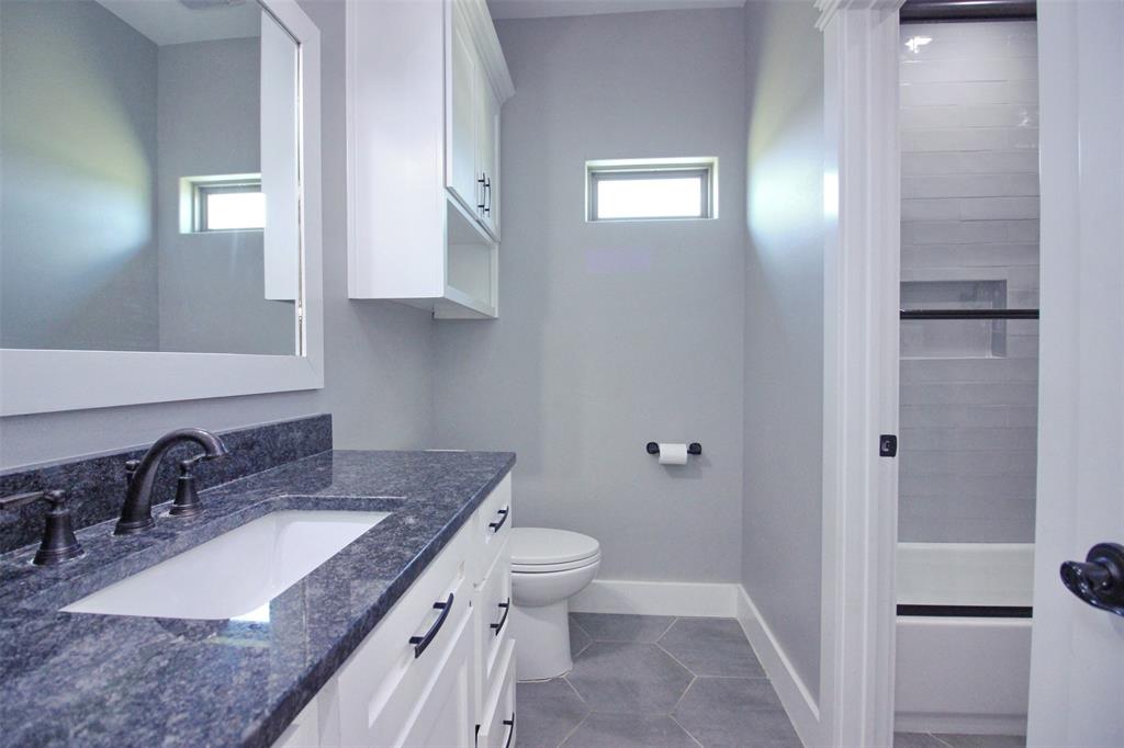 3238 Fm 2048 Boyd, TX 76023 - Photo 16 of 38 a bathroom with a granite countertop sink a toilet and a mirror