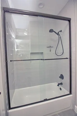 a bathroom with a granite countertop sink a toilet and a mirror