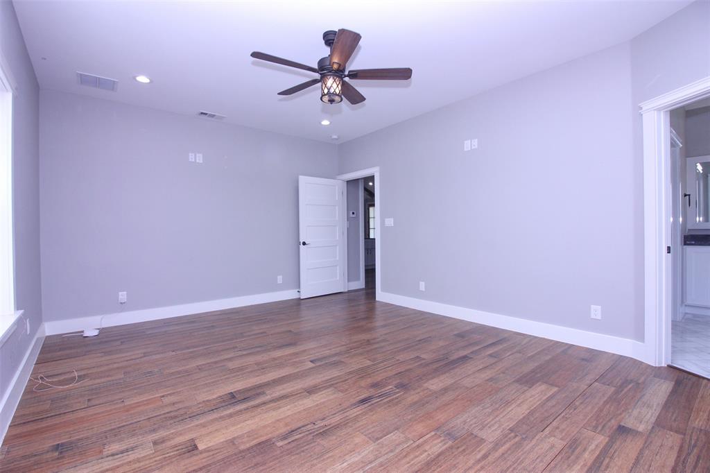 3238 Fm 2048 Boyd, TX 76023 - Photo 19 of 38 a view of an empty room with wooden floor and a ceiling fan