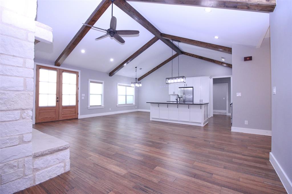 3238 Fm 2048 Boyd, TX 76023 - Photo 2 of 38 a view of an empty room with wooden floor and a ceiling fan