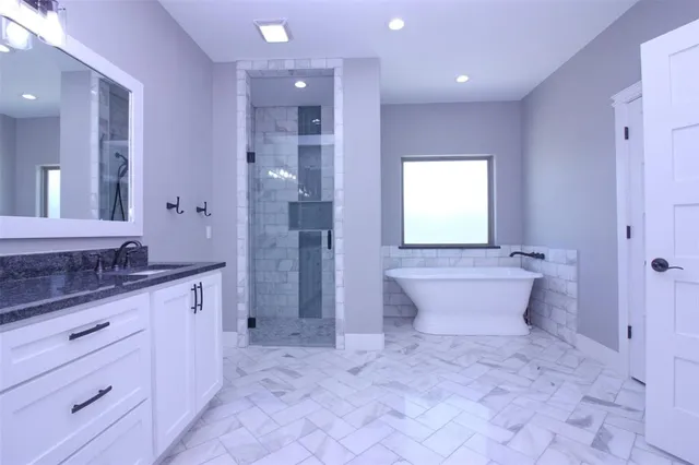 a view of an empty room with wooden floor and a ceiling fan