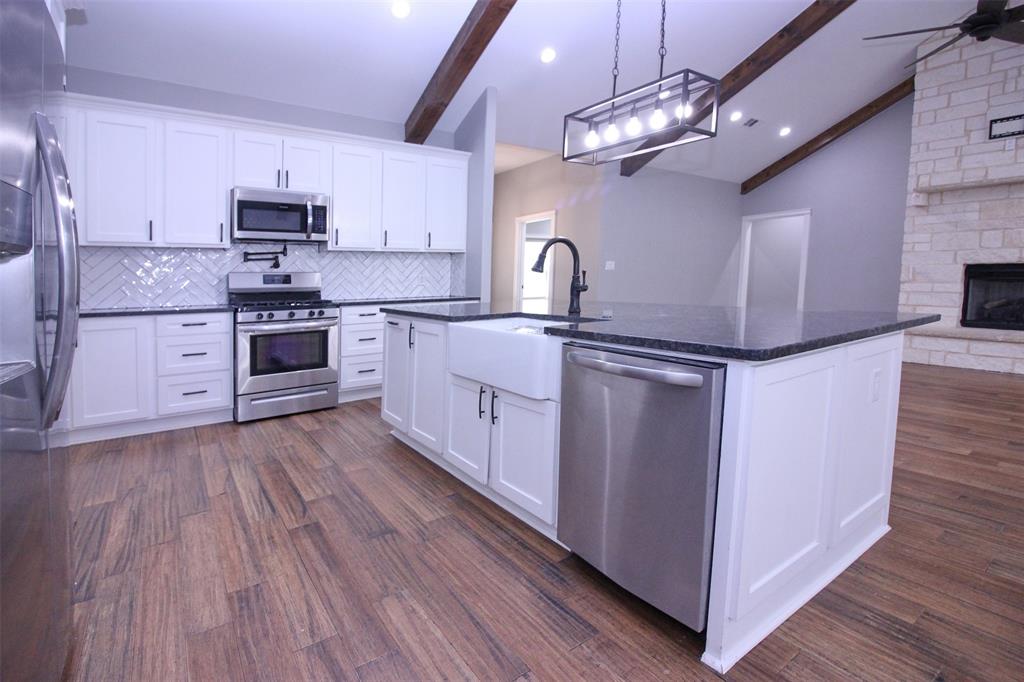 3238 Fm 2048 Boyd, TX 76023 - Photo 3 of 38 a kitchen with stainless steel appliances granite countertop a stove top oven a sink dishwasher and a refrigerator with wooden floor