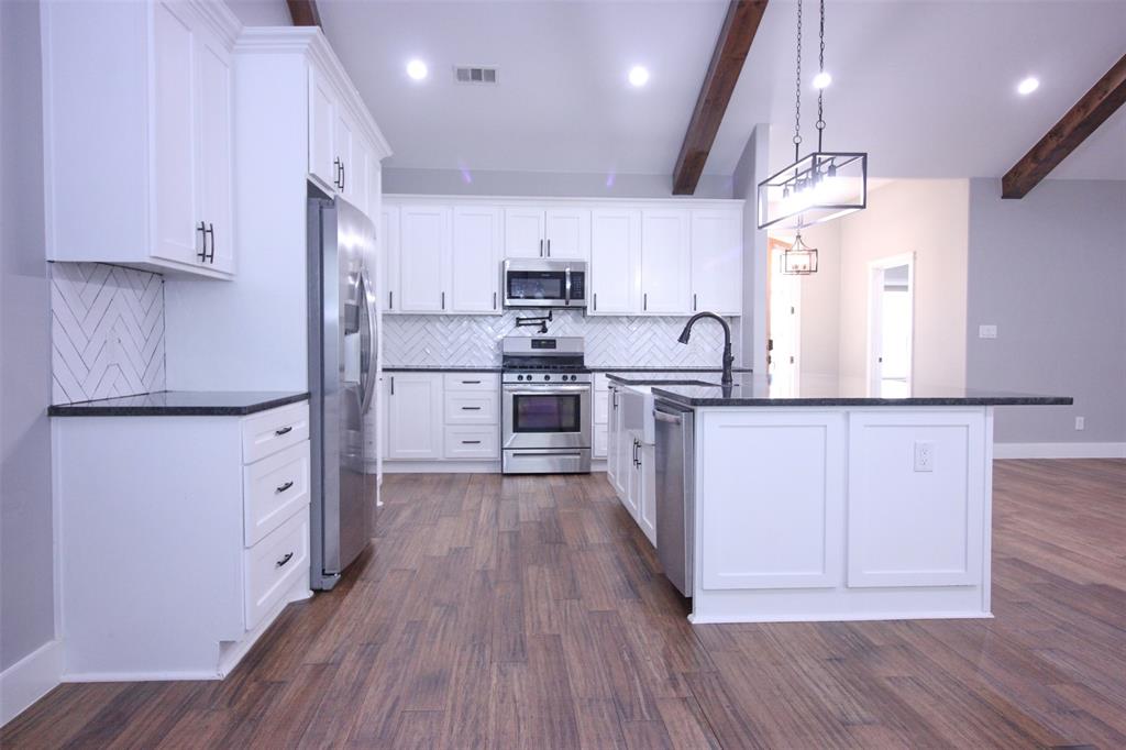3238 Fm 2048 Boyd, TX 76023 - Photo 6 of 38 a kitchen with white cabinets and stainless steel appliances