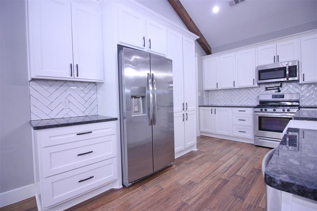 3238 Fm 2048 Boyd, TX 76023 - Photo 8 of 38 a kitchen with stainless steel appliances cabinets and a wooden floor