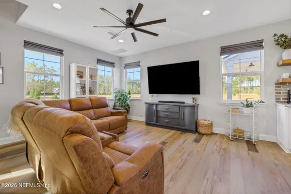 a kitchen with stainless steel appliances granite countertop wooden floors and wooden cabinets