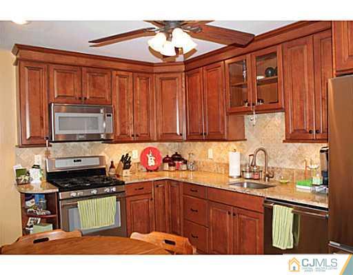 8 Colton Road Edison, NJ 08817 - Photo 1 of 19 a kitchen with stainless steel appliances a stove sink and cabinets
