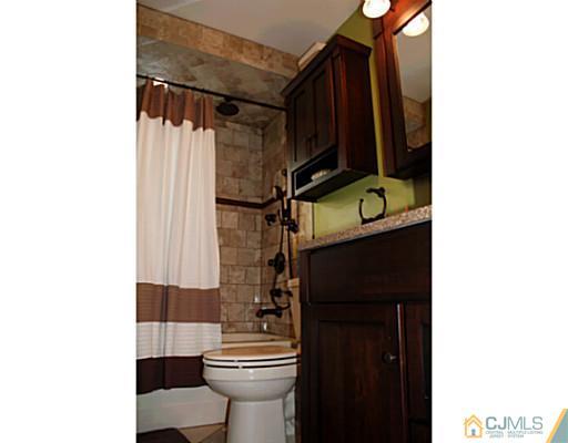 8 Colton Road Edison, NJ 08817 - Photo 2 of 19 a bathroom with a toilet and a shower