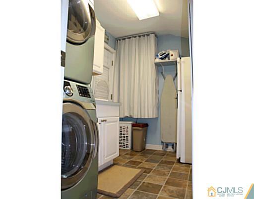 8 Colton Road Edison, NJ 08817 - Photo 14 of 19 a view of a storage and utility room with washer and dryer