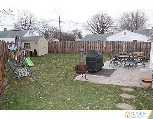 8 Colton Road Edison, NJ 08817 - Photo 15 of 19 a view of a patio with table and chairs with wooden fence