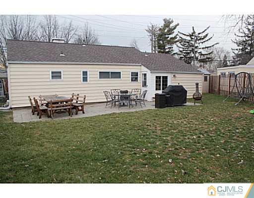 8 Colton Road Edison, NJ 08817 - Photo 16 of 19 a backyard of a house with table and chairs