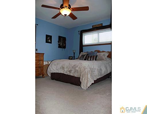 8 Colton Road Edison, NJ 08817 - Photo 4 of 19 a bedroom with a bed and window