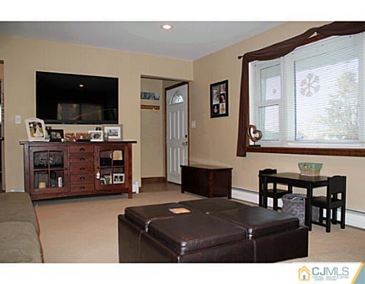 8 Colton Road Edison, NJ 08817 - Photo 5 of 19 a living room with furniture and a flat screen tv