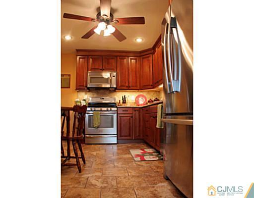 8 Colton Road Edison, NJ 08817 - Photo 6 of 19 a kitchen with a refrigerator and a stove