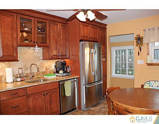 8 Colton Road Edison, NJ 08817 - Photo 7 of 19 a kitchen with stainless steel appliances granite countertop a refrigerator and a sink