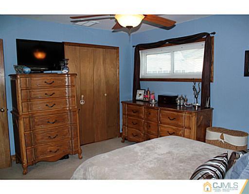 8 Colton Road Edison, NJ 08817 - Photo 10 of 19 a bedroom with a bed and a flat screen tv