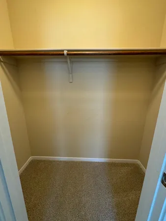 a view of empty room with wooden floor and cabinet