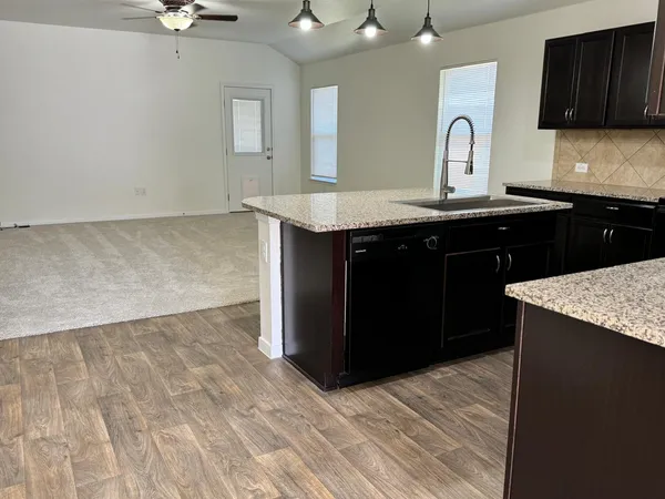 a kitchen with a sink and a refrigerator