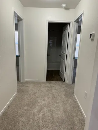 an empty room with a ceiling fan and window