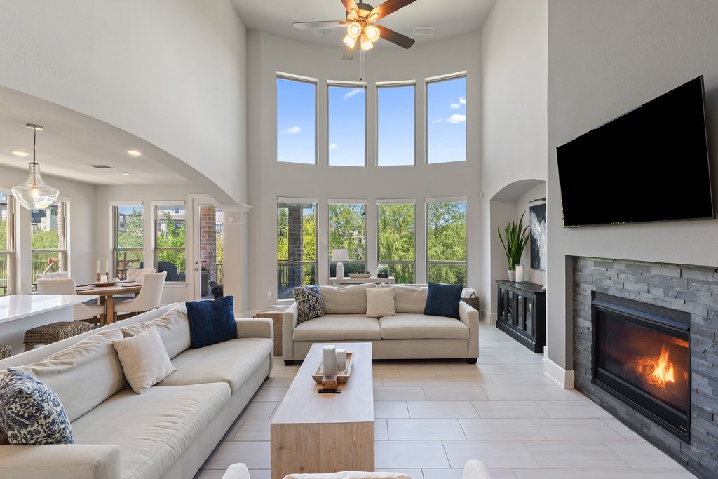 741 Rawson Bend Austin, TX 78738 - Photo 9 of 40 The living room impresses with soaring two story ceiling and stacked windows that frame greenbelt views.