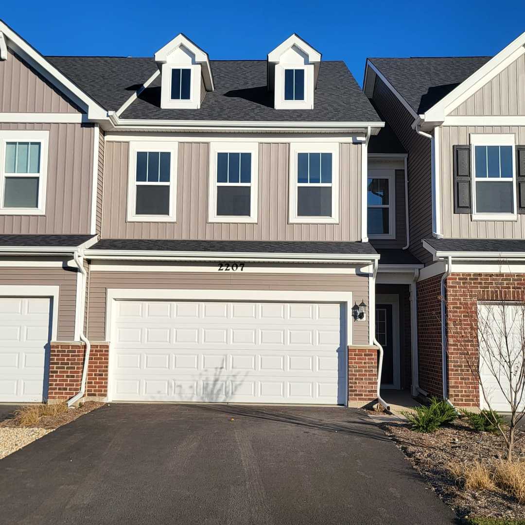 2207 Horseshoe Circle, Unit 2207 Plainfield, IL 60585 - Photo 1 of 33 a front view of a house with lots of windows