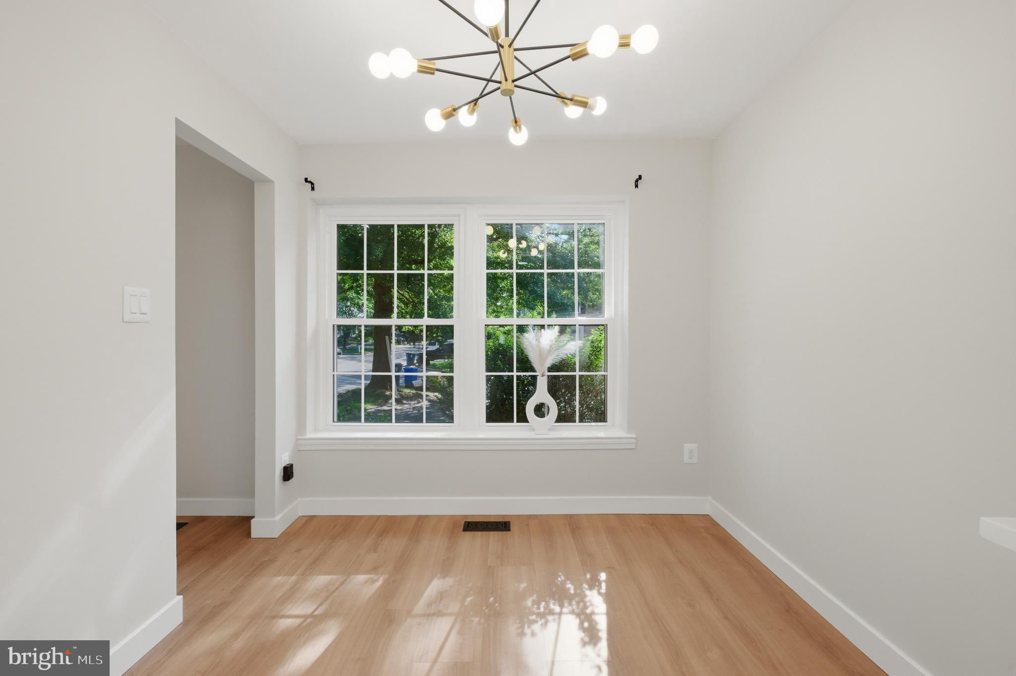 8575 Tyrolean Way Springfield, VA 22153 - Photo 11 of 29 a view of an empty room with wooden floor and a window