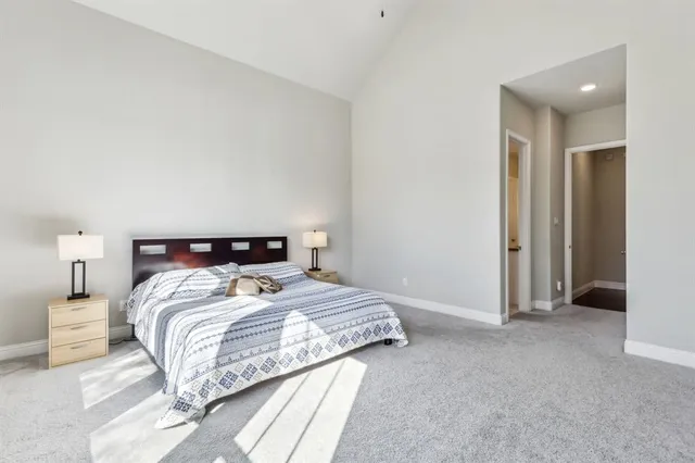 a bedroom with a bed and a lamp